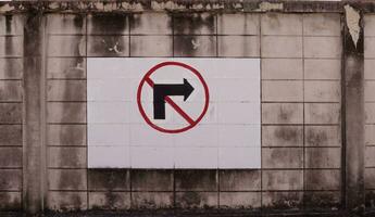 No turn right sign on white background on old and dirty concrete wall. photo