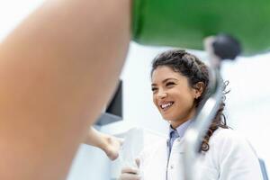 woman doctor, gynecologist examines a patient who is sitting in a gynecological chair. Examination by a gynecologist. Female health concept. photo