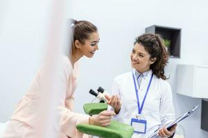 Gynecologist showing a picture with ultrasound to a young woman patient, explaining the features of women's health during a medical consultation in the office photo