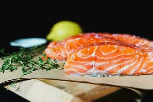 Fresh raw salmon fillet with seasonings and herbs photo