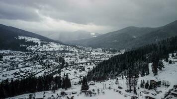 Aerial View of idyllic high-rise touristic place in Carpathian Mountains, foggy weather, winter season photo