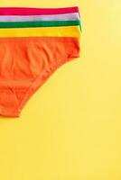 Set of colorful underpants on yellow background photo