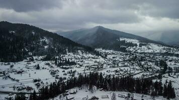 Aerial View of idyllic high-rise touristic place in Carpathian Mountains, foggy weather, winter season photo