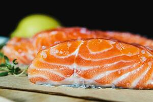 Fresh raw salmon fillet with seasonings and herbs photo