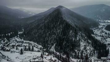 Aerial View of idyllic high-rise touristic place in Carpathian Mountains, foggy weather, winter season photo