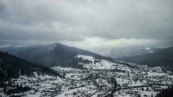 Aerial View of idyllic high-rise touristic place in Carpathian Mountains, foggy weather, winter season photo