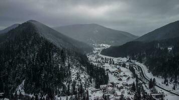 Aerial View of idyllic high-rise touristic place in Carpathian Mountains, foggy weather, winter season photo