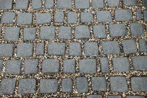 Texture of cobble stone pavement floor and grey pebbles as decoration on footpath background photo