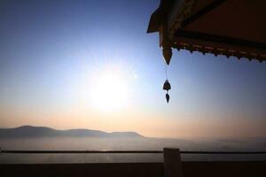 Gold brass Bells Hanging on pagoda in temple is located on the mountain for blue sky, Thailand photo