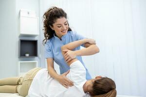 Physiotherapist treatment patient. Holding patient's hand, shoulder joint treatment. Physical Doctor consulting with patient About Shoulder muscule pain problems Physical therapy diagnosing concept photo