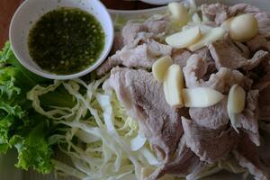 Delicious Boiled spicy pork with lime garlic and chili sauce. photo