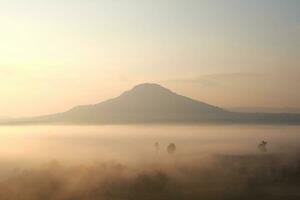 Beautiful Sunset and sunrise on sky and golden twilight time with mist and fog in valley of layer mountain photo