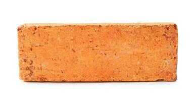 Single cracked old red or orange brick isolated on white background with clipping path photo