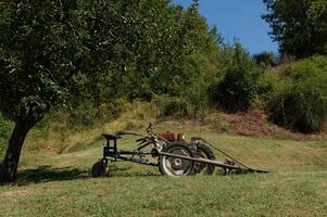 A modification of the model of an old tractor on green grass in summer landscape photo