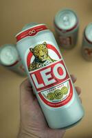 Bangkok, Thailand - October 8, 2023 Holds a can of popular Thai beer Leo with new logo. Brand Leo beer created by boon rawd brewery co.,ltd in Thai. photo