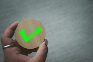 Chosen green check mark by business's hand photo