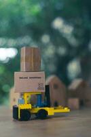 Mini forklift truck load cardboard box with text online shopping. Fast delivery. photo