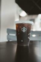 Bangkok, Thailand - October 16, 2023 A cup of reusable cup cold Americano 25th Anniversary. Limited-edition photo