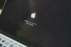 Bangkok, Thailand - October 16, 2023 iOS firmware update process on the screen at the Apple MacBook. photo