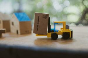 Forklift and cardboard box against nature background photo