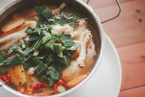 Sour and spicy chicken feet soup photo