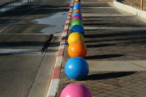 A row of pillars along the road for the safe passage of pedestrians along the sidewalk. photo