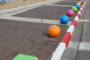 A row of pillars along the road for the safe passage of pedestrians along the sidewalk. photo