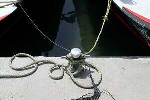 Thick hemp rope on the pier in the seaport. photo