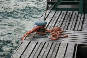 Thick hemp rope on the pier in the seaport. photo