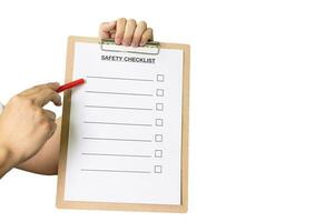 Pointing at blank Safety Checklist with red pen isolated on white background. photo