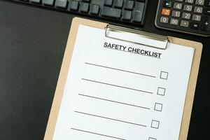 Blank checklist paper during safety audit and risk verification. safety checklist form on the desk. photo