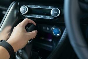 Driver hand holding transmission shift gear. The driver shifts into gear to drive and travel, Automotive concept. photo