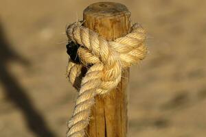 Thick hemp rope on the pier in the seaport. photo