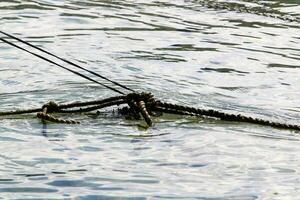 Thick hemp rope on the pier in the seaport. photo