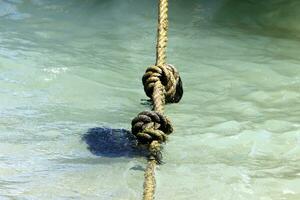 Thick hemp rope on the pier in the seaport. photo