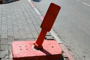 A row of pillars along the road for the safe passage of pedestrians along the sidewalk. photo