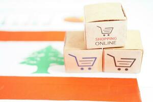 Online shopping, Shopping cart box on Lebanon flag, import export, finance commerce. photo