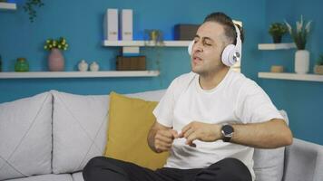 Happy man listening to music with headphones. video