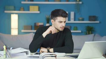 Serious and focused working man thinks in front of what he sees on the screen. video