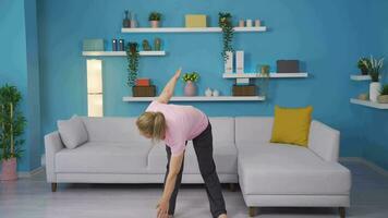 Woman exercising at home stretching her arms. Healthy life fitness. video