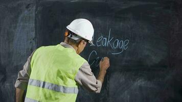 Engineer man writes leakage current on the board. video