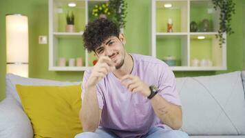 Young man laughing and making hearts. video