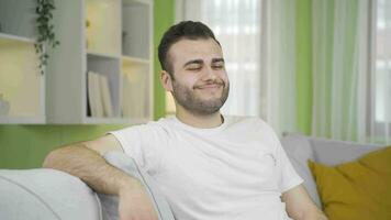 Man relaxing and resting on sofa at home. video