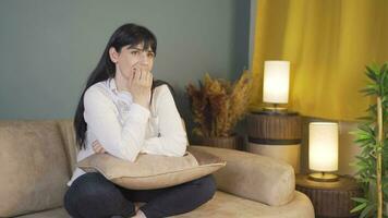 Woman biting her nails because of stress at home at night. video