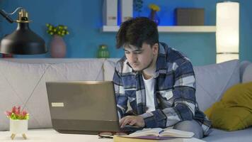 Man focusing on computer has serious expression. At home at night. video