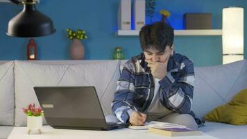 Stressed and depressed male student at home at night. video