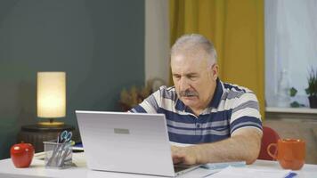 Home office worker man working on laptop stressed. video
