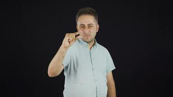 The man making the small sign with his hand. video