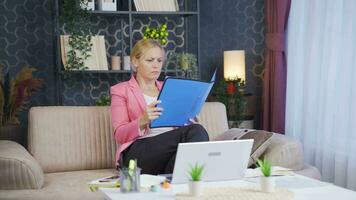 Home office worker woman looking at the file angrily. video