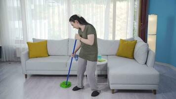 The woman cleaning by dancing is happy. video